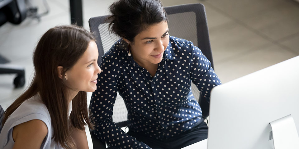 two women working together in an office